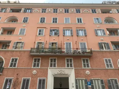 a large red brick building with a balcony at Casa Romi in Rome
