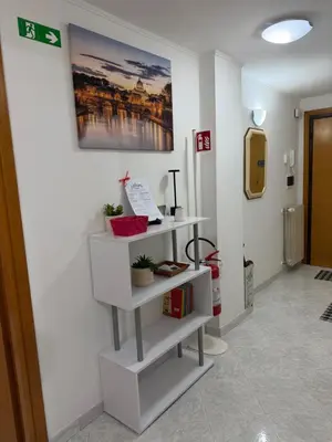 a room with white shelves on a wall at Casa Romi in Rome