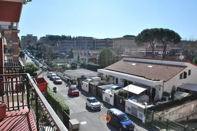 a city street with cars parked in a parking lot at Appartamento Gemelli - Val Favara Apartment in Rome