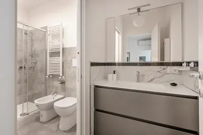 a white bathroom with a sink and a toilet at Vatican Manu Home in Rome