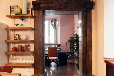 a dining room with a mirror and a table at Charme Apt in Piazza Monti in Rome