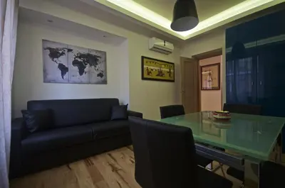 a living room with a glass table and a couch at Piramide House in Rome