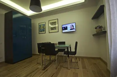 a dining room with a table with chairs and a laptop at Piramide House in Rome