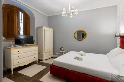a bedroom with a bed and a tv on a dresser at Domus 15 - Guest House in Rome