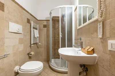 a bathroom with a toilet and a sink and a shower at Domus 15 - Guest House in Rome