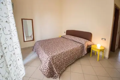 a bedroom with two beds and a table and a mirror at ad duas lauros in Rome