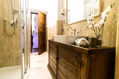 a bathroom with a sink and a mirror at Reco Luxury Suite Rome in Rome