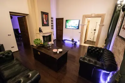 a living room with leather furniture and a fireplace at Reco Luxury Suite Rome in Rome