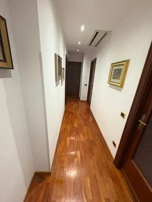 a hallway with white walls and a wooden floor at Apartment in Trastevere 41 in Rome