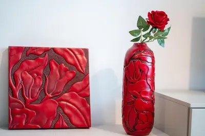 a red vase with a rose in it next to a painting at Luxury Sweet Home Labicana in Rome