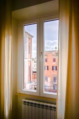 a window with a view of a building at Collection39 Scipioni Luxury Penthouse in Rome