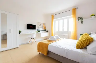 a bedroom with a large bed and a window at Domvs Clavdia - 7min to Colosseum by Metro, Station under apt, Roma, 6pax, A-C in Rome