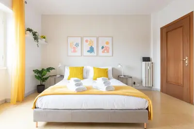 a bedroom with a large bed with towels on it at Domvs Clavdia - 7min to Colosseum by Metro, Station under apt, Roma, 6pax, A-C in Rome
