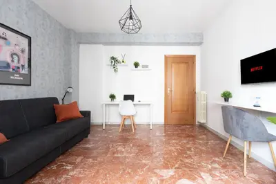 a living room with a couch and a table at Domvs Clavdia - 7min to Colosseum by Metro, Station under apt, Roma, 6pax, A-C in Rome