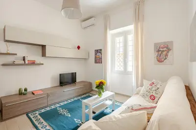 a living room with a couch and a tv at Casa Polly in Rome