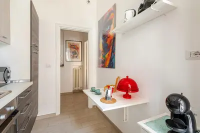a kitchen with a table with a red lamp on it at Casa Polly in Rome