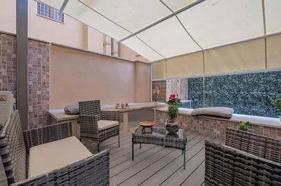 a patio with chairs and a table on a deck at Carlo's House Suite with Private Terrace in Rome