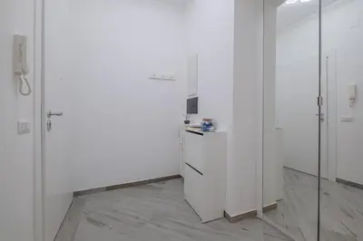 a white room with white walls and glass doors at Carlo's House Suite with Private Terrace in Rome
