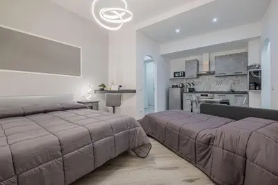 a large bedroom with two beds and a kitchen at Carlo's House Suite with Private Terrace in Rome