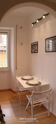 a white table and chairs in a room with a window at Appartamento Cornelia near San Pietro in Rome