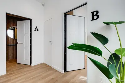 a hallway with two mirrors and a plant at Scipioni Luxury Apartment in Rome