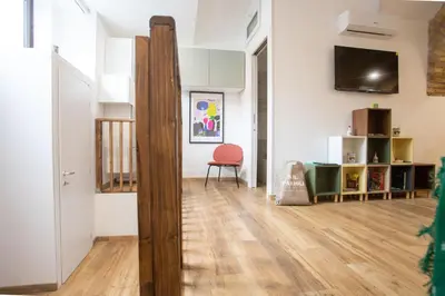 a room with a wooden pole in the middle of a room at Troppo Forte appartamento a due passi dal Colosseo in Rome