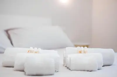 four rolls of toilet paper sitting on a table at 10 Min from Termini Sisters Cozy Rome Apartment in Rome
