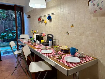 a kitchen with a table with plates of food on it at Casa Orietta in Rome