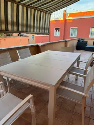 a table and chairs sitting on a roof at The Monteverde Penthouse in Rome
