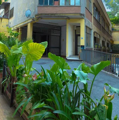 a building with a bunch of plants in front of it at Appartamento Rea Silvia in Rome