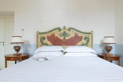 a bedroom with a large bed with two side tables at Casa Giulia, a Burghesius home in Rome