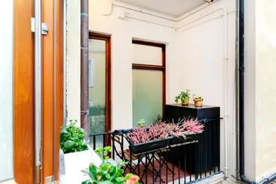 a balcony with potted plants on a building at Dimora Cavallini in Rome