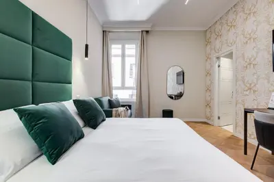a bedroom with a large bed with a green headboard at Dionigi 43 Private Suites by Premium Suites Collection in Rome