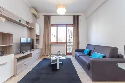 a living room with a couch and a tv at St Peter apartment with Garage in Rome