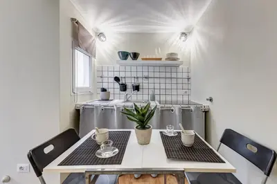 a small kitchen with a table and chairs at La Casina your suite in Monti in Rome