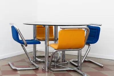 a table with four chairs around it at Casa Assunta in Rome