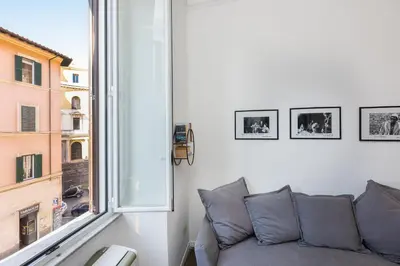 a living room with a couch and a window at Casa Assunta in Rome