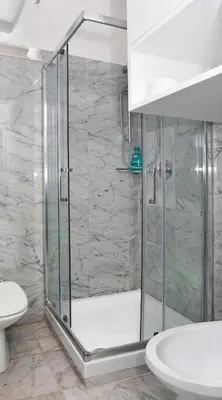 a bathroom with a shower with a toilet and a sink at Vittoria Charme in Rome