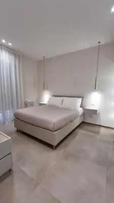 a bedroom with a large bed and two lamps at T&T Luxury Home Rome Int 5 in Rome