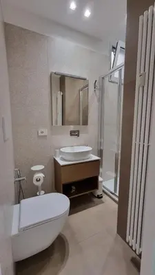 a bathroom with a toilet and a sink and a mirror at T&T Luxury Home Rome Int 5 in Rome