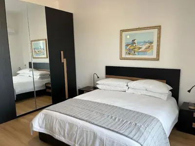 a bedroom with a large bed and a mirror at Tiburtina Sky Loft in Rome