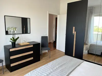 a bedroom with a bed and a dresser with a mirror at Tiburtina Sky Loft in Rome