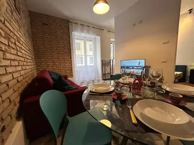 a dining room with a table and a couch at Lilla a Testaccio in Rome