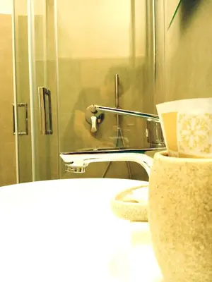 a bathroom with a toilet and a sink and a mirror at DOMUS REMO Room #1 in Rome