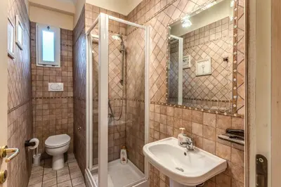 a bathroom with a sink and a toilet and a shower at Casa Vacanze San Giovanni in Rome