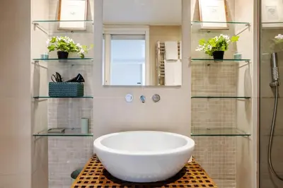 a bathroom with a tub and a window and plants at Your nest with wooden ceilings in Monti in Rome