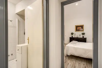 a bathroom with a bed and a mirror at Casa Vacanze Crispi in Rome