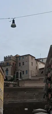 a view of a city with buildings in the background at Front Vatican museum in Rome
