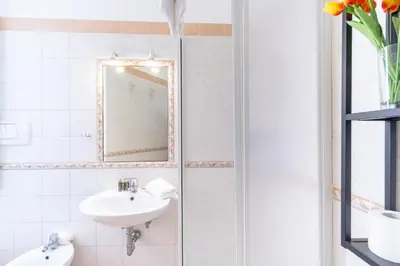 a bathroom with a sink and a mirror at Elegantis La Dolce Vista Apartment with private terrace and fantastic View in Rome
