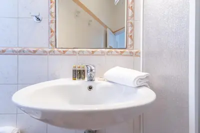 a white sink in a bathroom with a mirror at Elegantis La Dolce Vista Apartment with private terrace and fantastic View in Rome